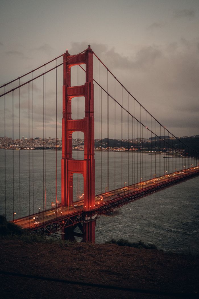 A dramatic view of the iconic Golden Gate Bridge at dusk, showcasing its architectural beauty.